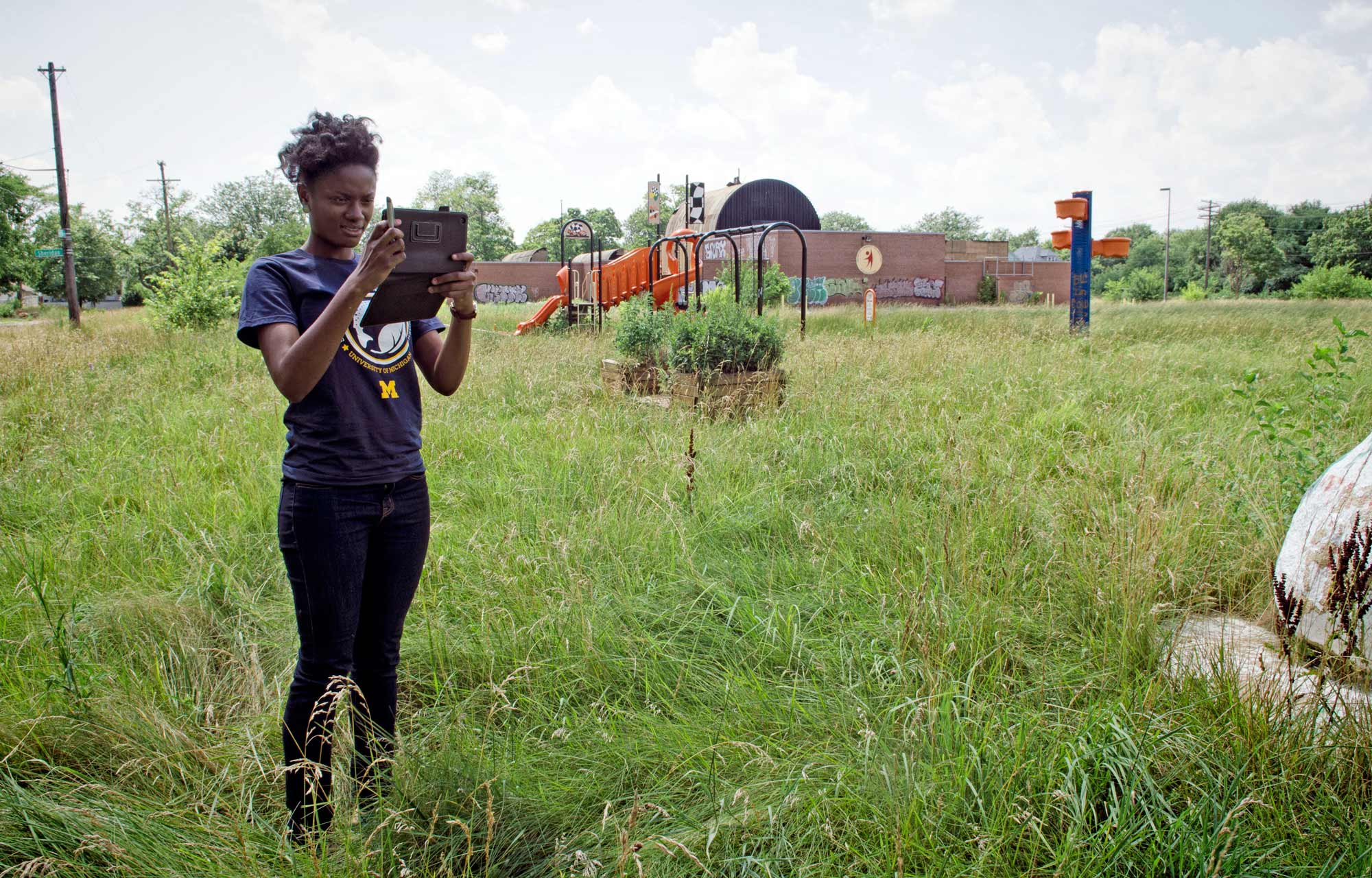 Jasmine Omeke photographs footpaths across an abandoned school yard, in the Detroit's East side in 2013. Image Credit: Dave Brenner/SNRE 