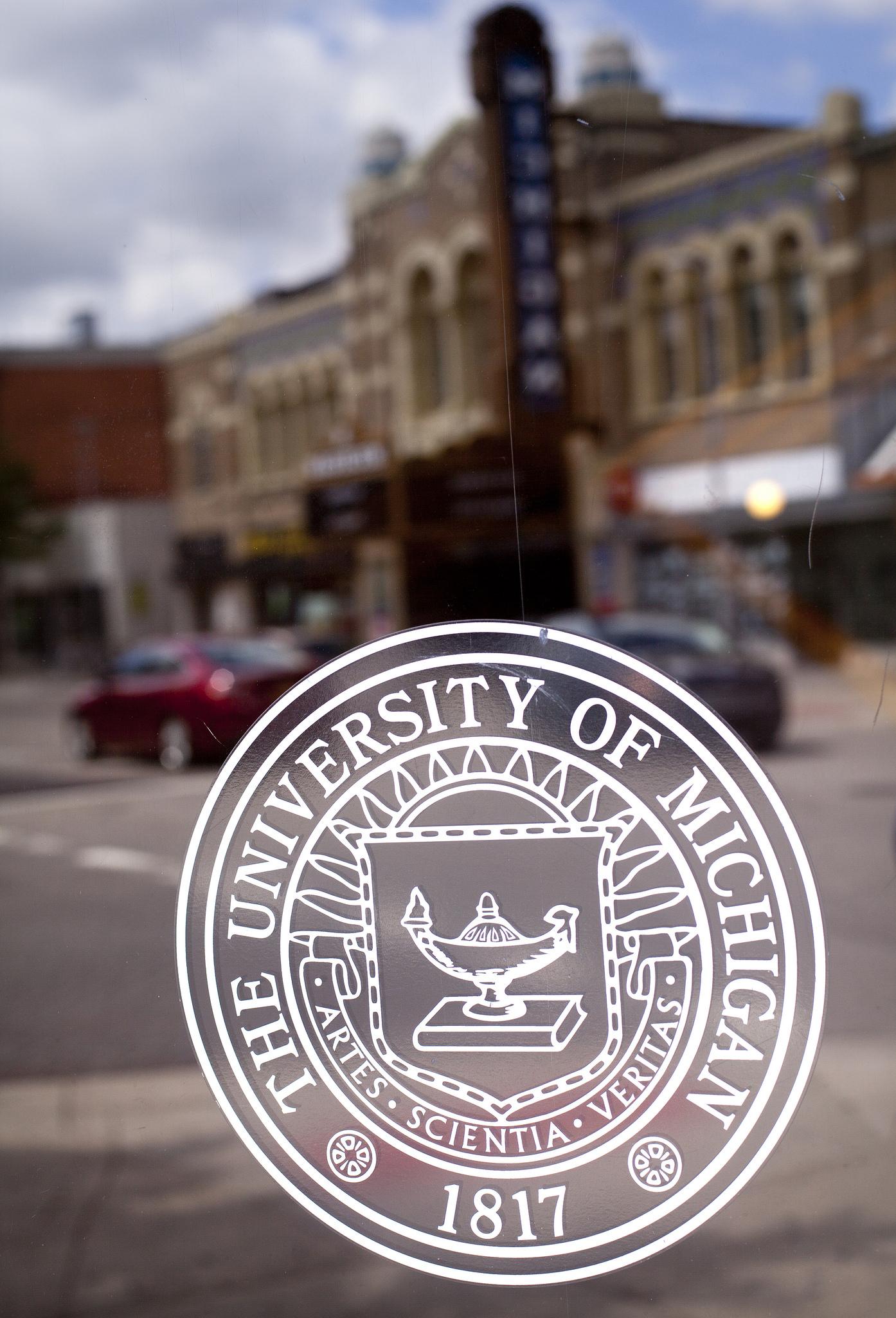 University of Michigan seal on a glass door.