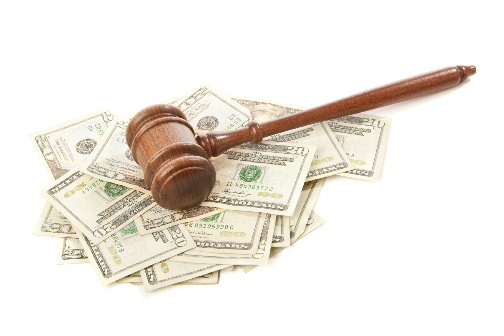 Gavel laying on top of money isolated. (tock image)