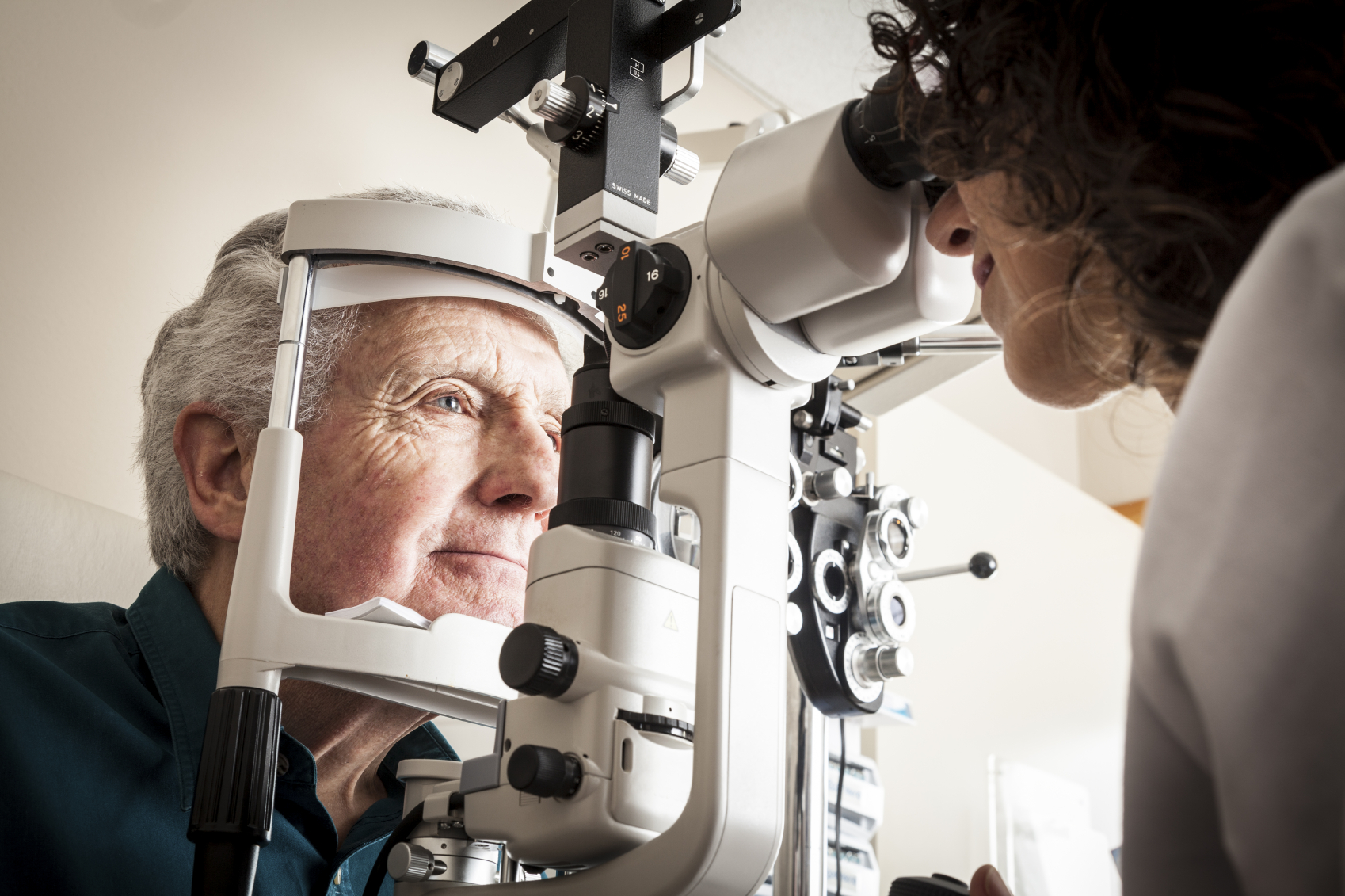 Optometrist with patient. (stock image)