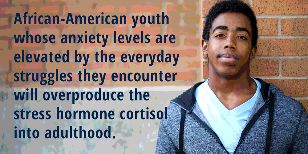 An African American teenager against a brick wall. (stock image)