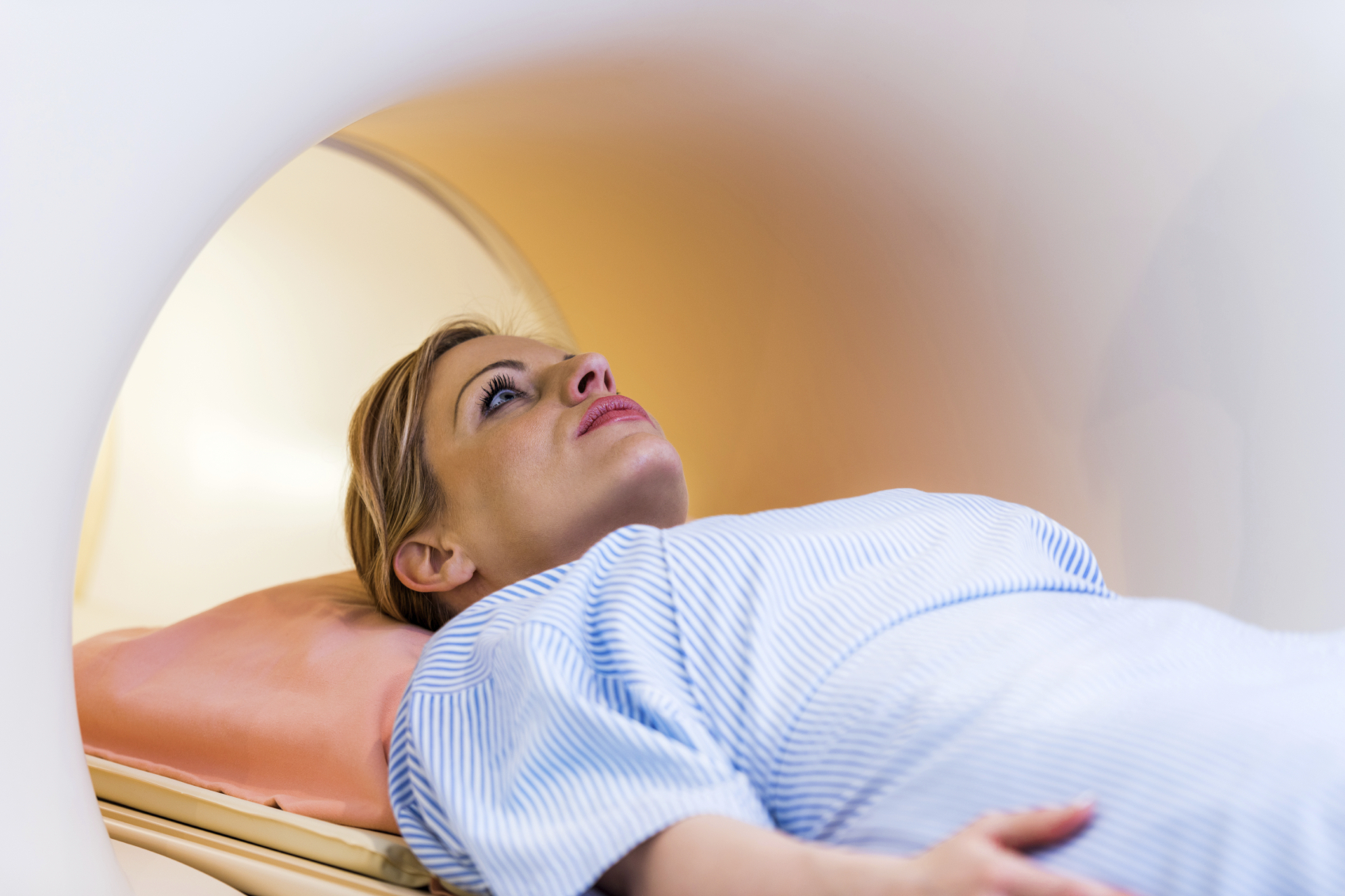 A young woman in an MRI machine. (stock image)
