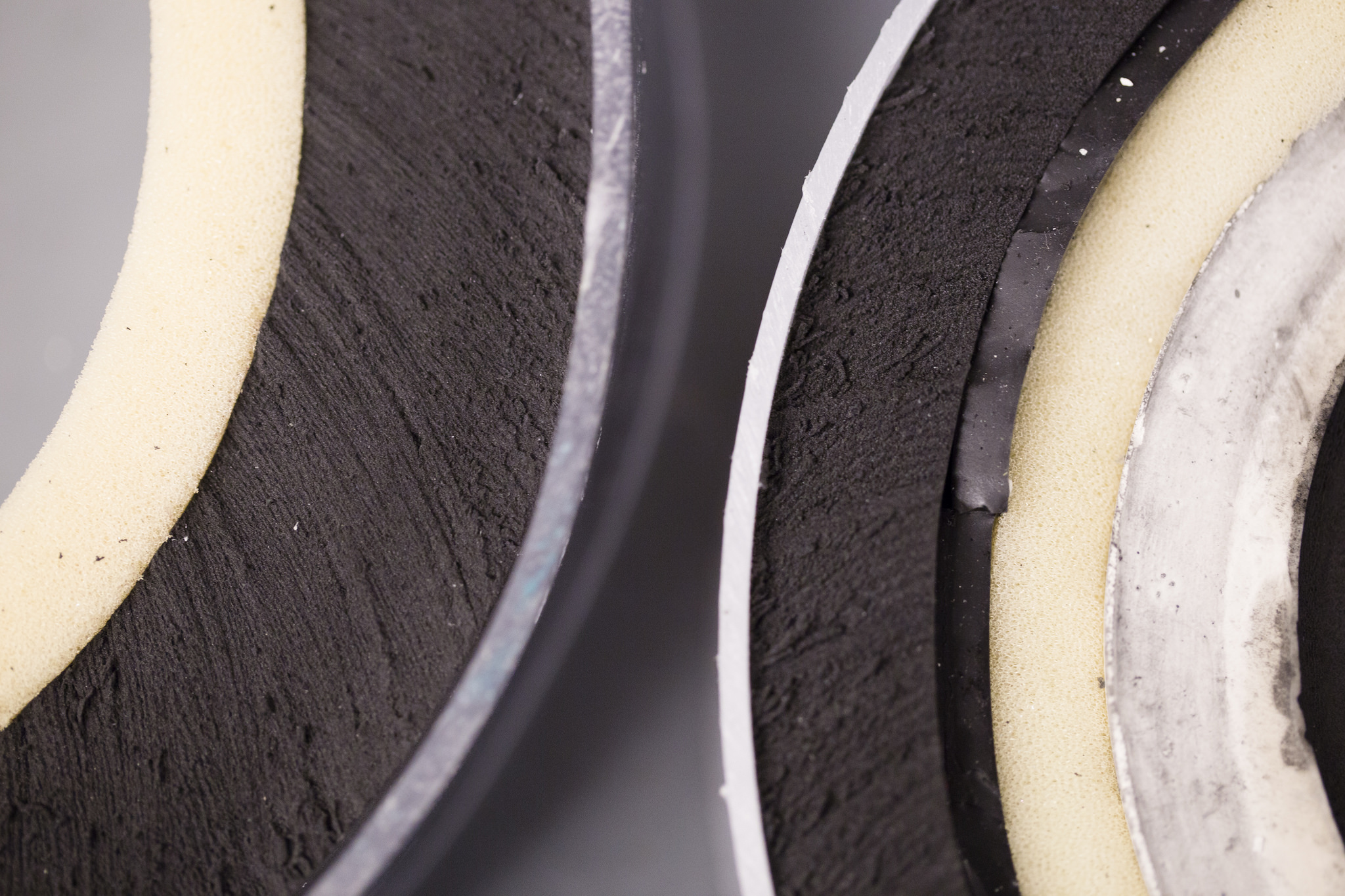 Layering on the left represents the padding in current football helmets, while the layering on the right shows off the new material (the thin, shiny and black layer).    Photo: Evan Dougherty, Michigan Enginering Communications & Marketing