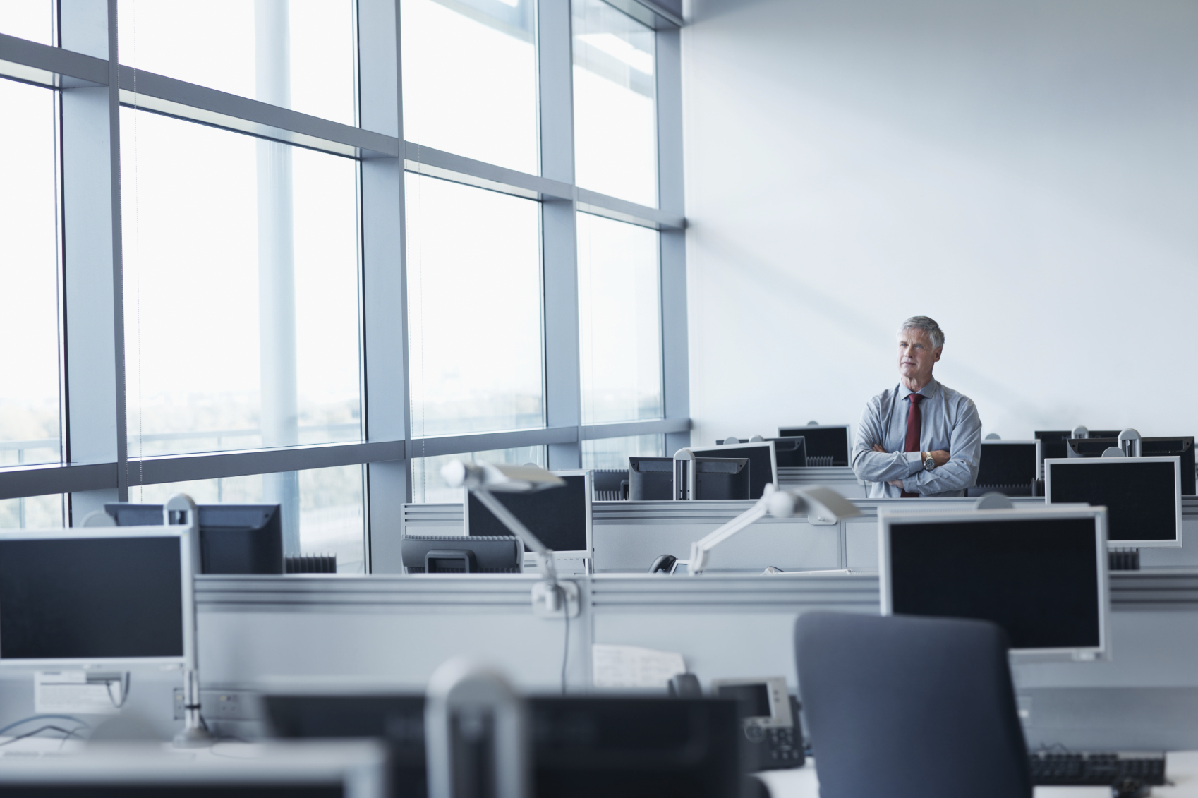 Company executive stands alone in an office. (stock image)