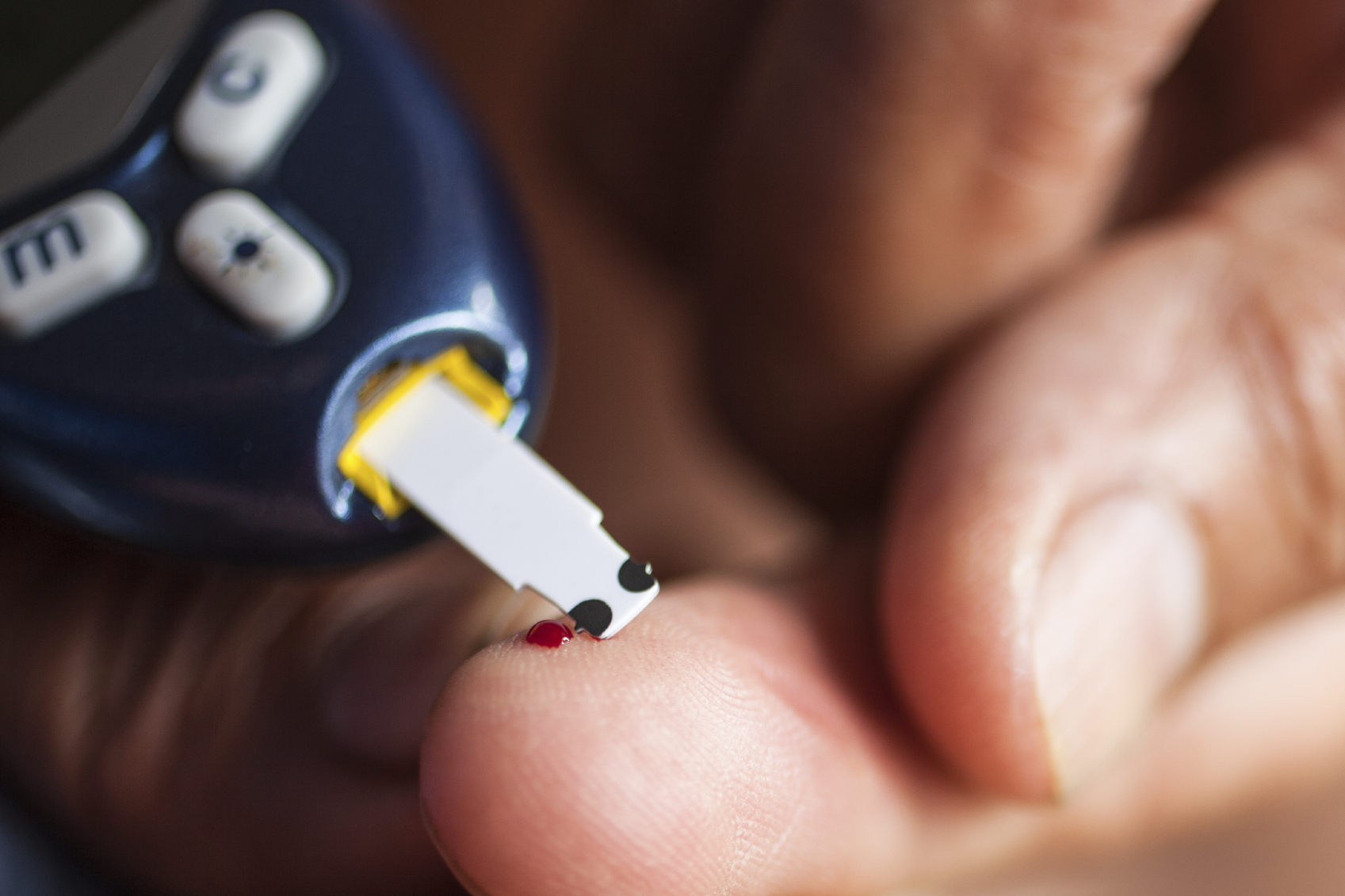 A Native American checks his blood sugar. (stock photo)