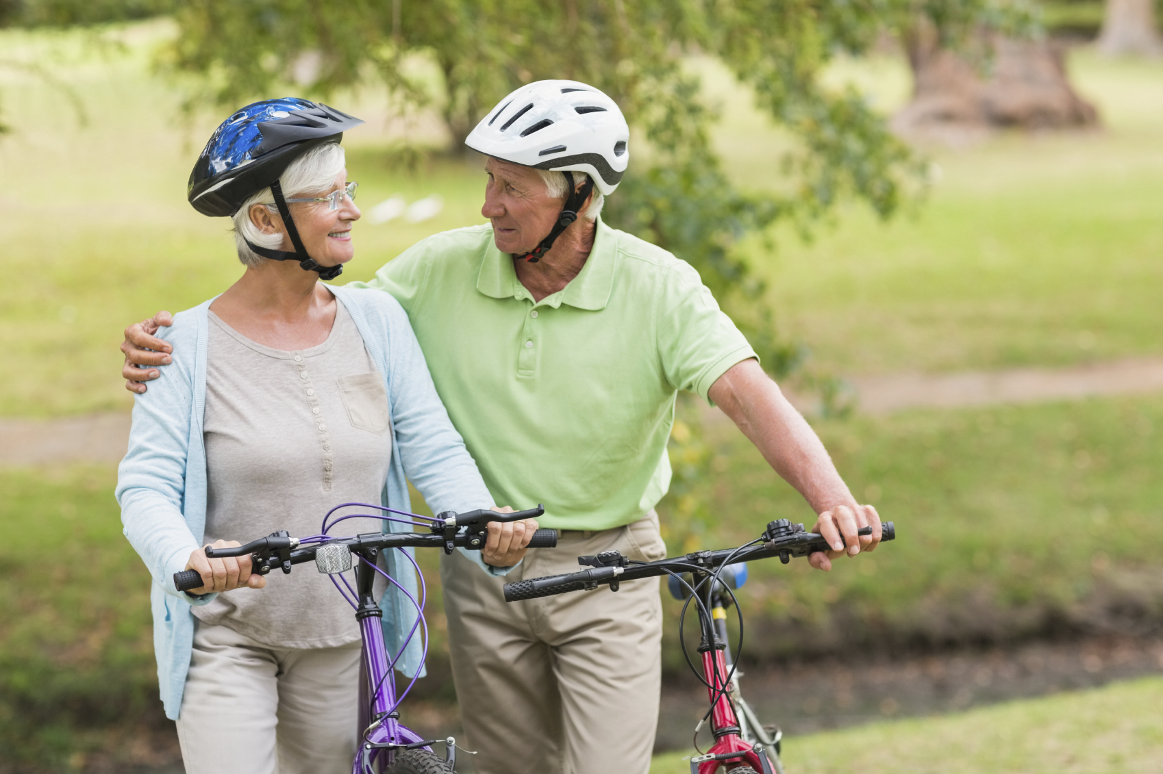 Happy senior couple on their bikes. (stock image)
