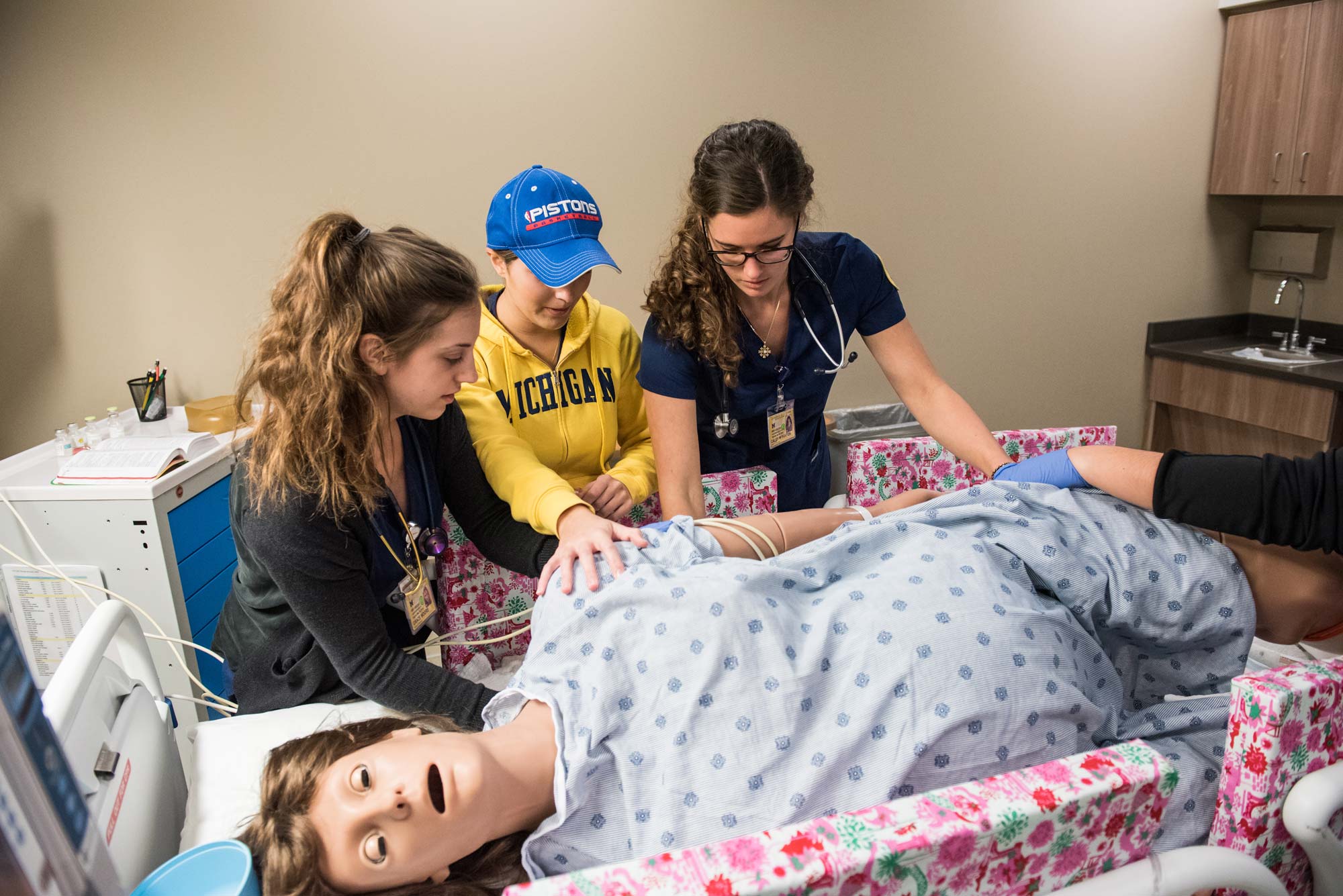 U-M Nursing students turn the Victoria mannequin on her side during a programmed seizure. Image credit: Michigan Photography