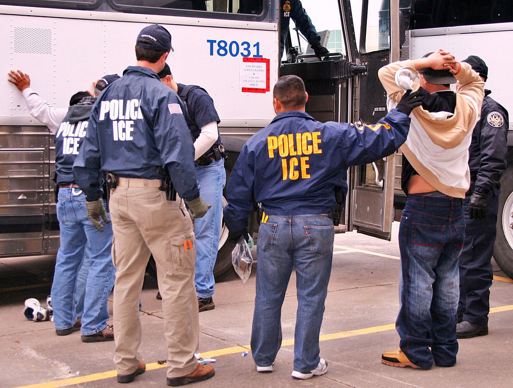 ICE Special Agents (U.S. Immigration and Customs Enforcement) arresting suspects during a 2010 raid in Houston. Image courtesy of ICE via Wikimedia Commons