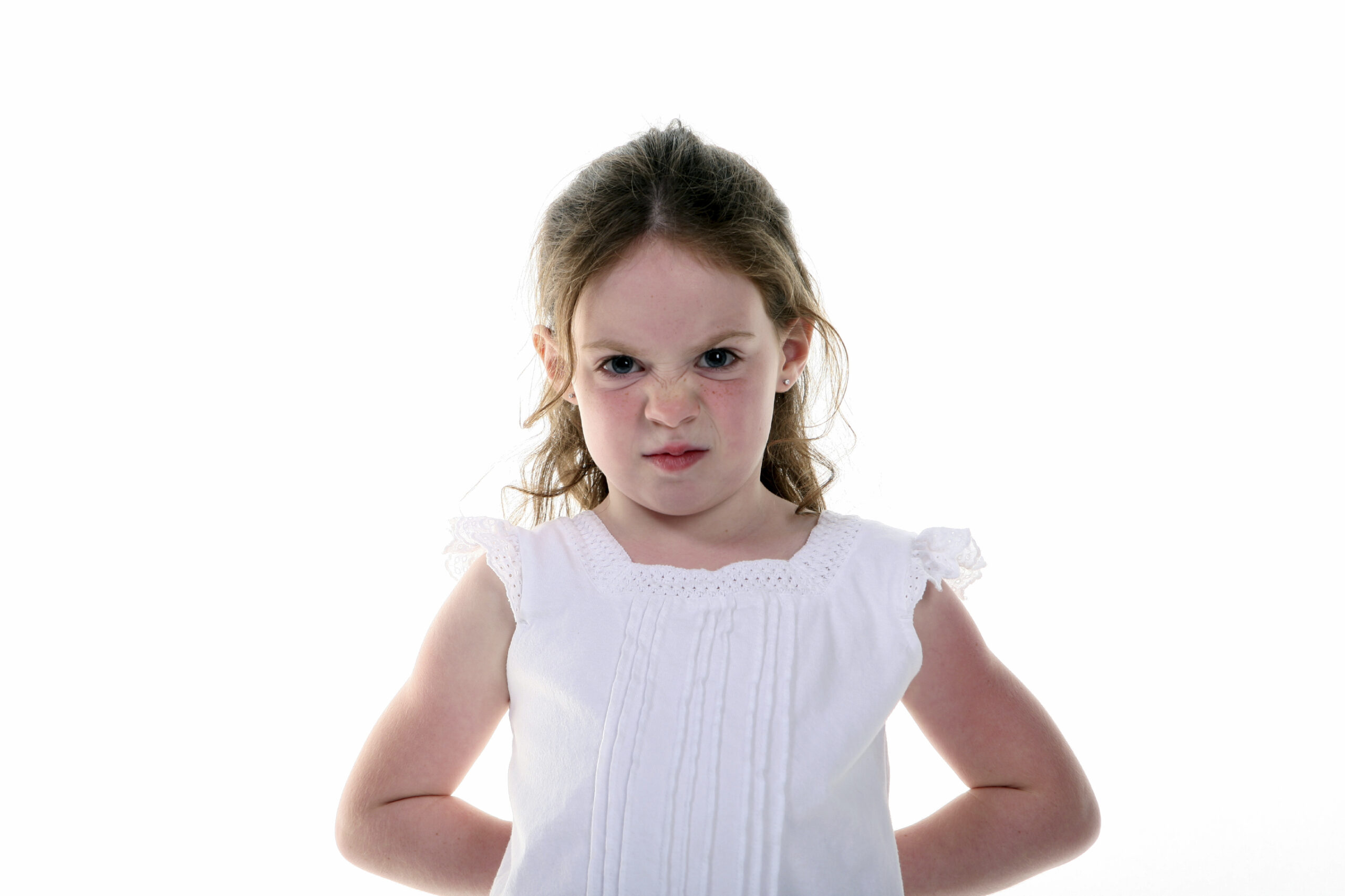 A very young girl with a bratty expression. (stock image)