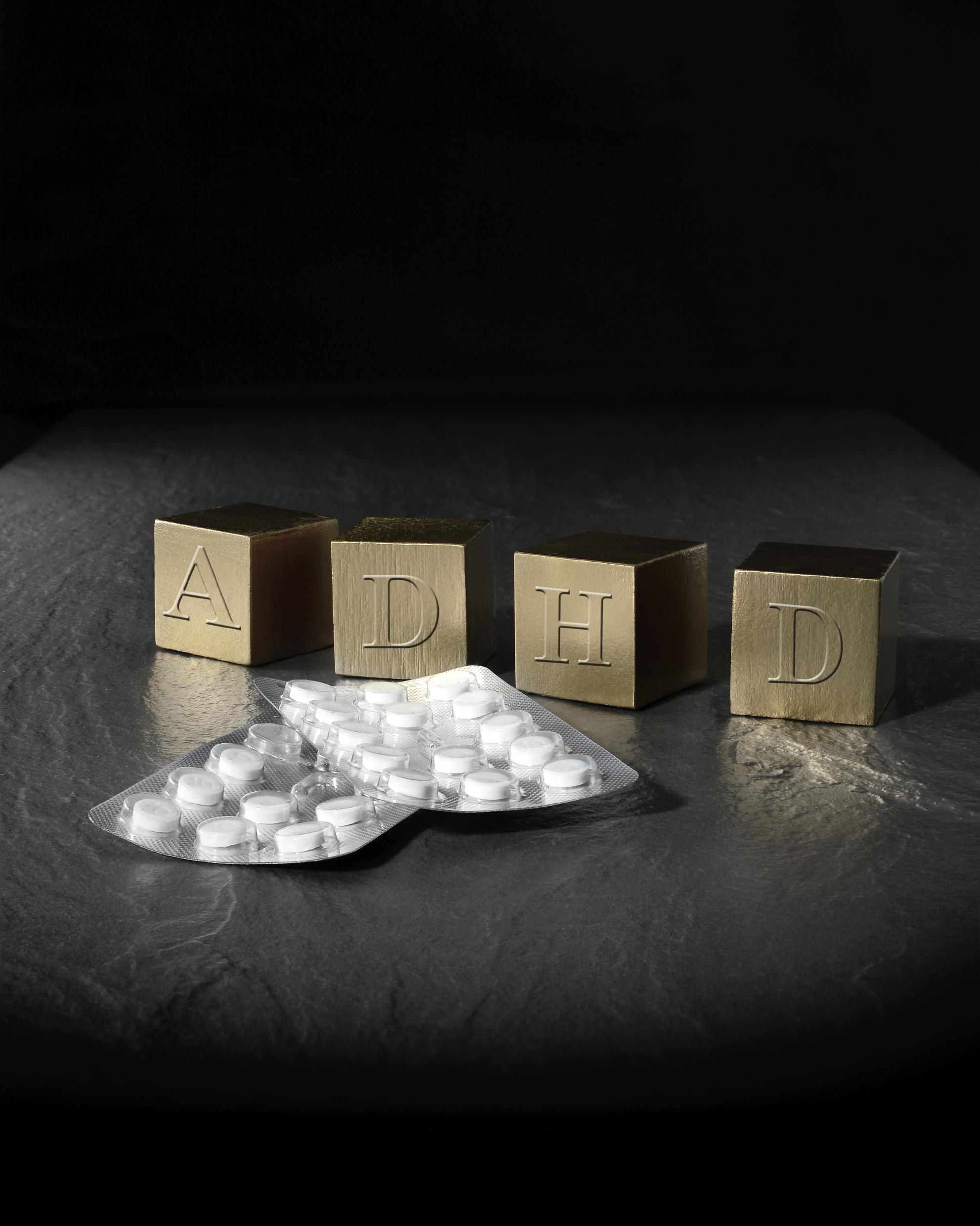 Concept image with blocks spelling ADHD and prescription pills. (stock image)