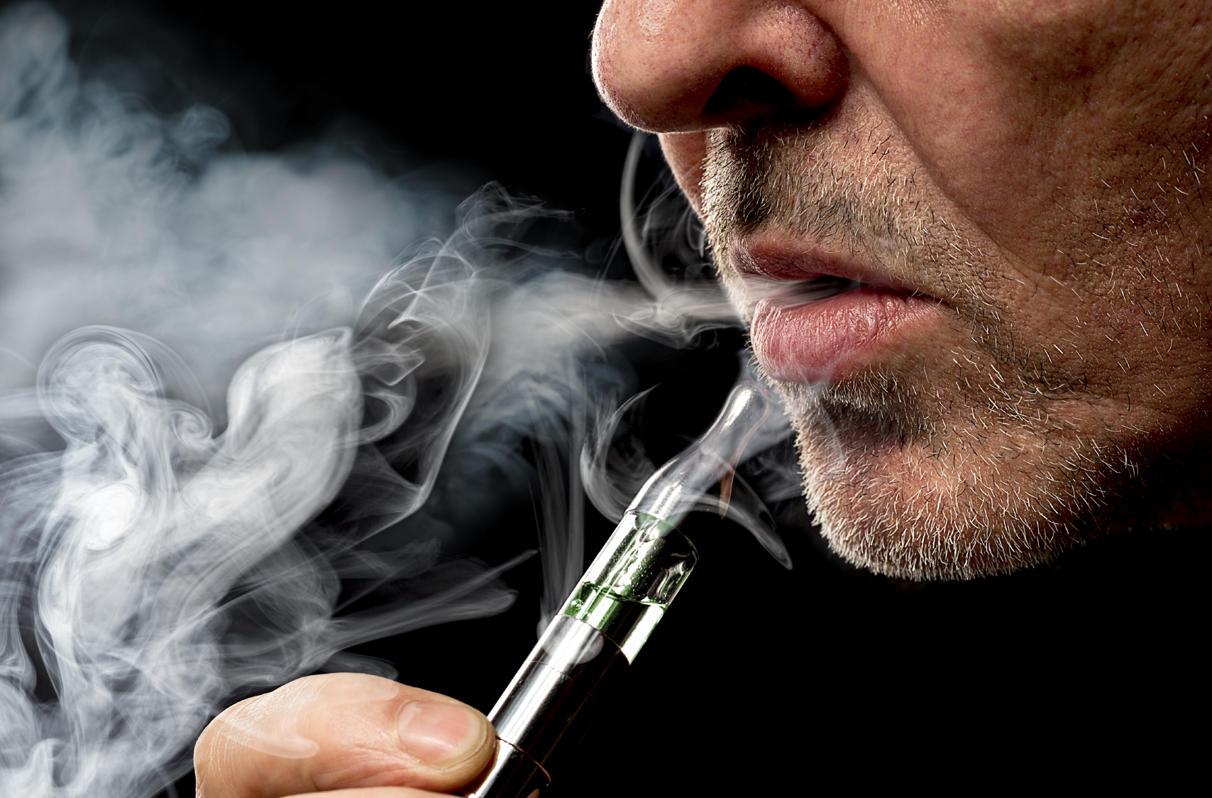 A man smokes an e-cigarette. (stock image)