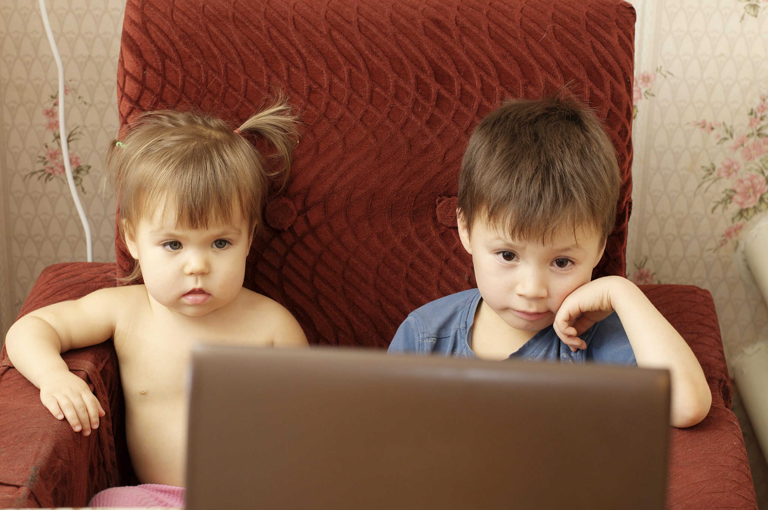 Children wathing cartoons on the notebook. (stock image)