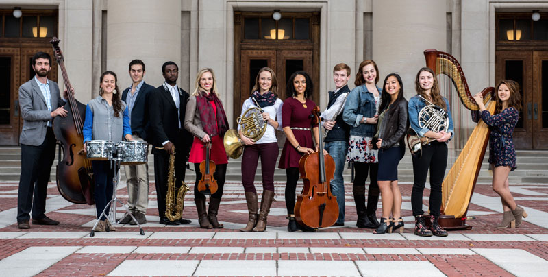 University of Michigan School of Music, Theatre & Dance students outside of Ann Arbor's historic Hill Auditorium.  The first $100,000 grand prize winner of the M-Prize Chamber Arts Competition will be awarded at Hill Auditorium on May 20, 2016.  Left to Right: Andrew Peck, Nicole Patrick, Max Karmazyn, Stephen Grady, Heather Kendrick, Anna Gilpatrick, Anita Graef, Bret Patterson, Anna Thompson, Belinda Rosen, Annie Jeng, Christine Stinchi, Catherine Miller. Credit: Eric Bronson