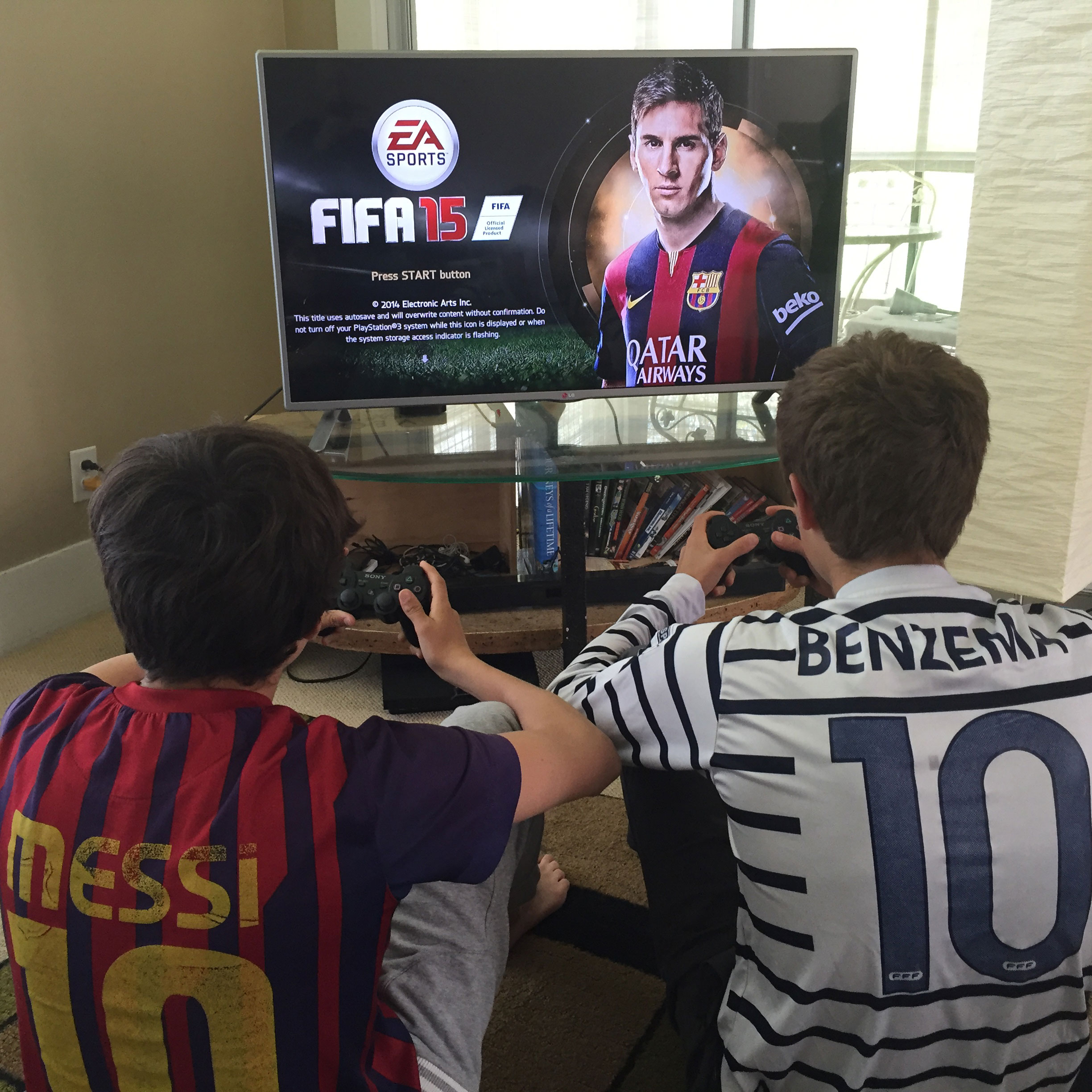 Two boys playing EA Sports FIFA, a video soccer game. Image credit: Nardy Baeza Bickel