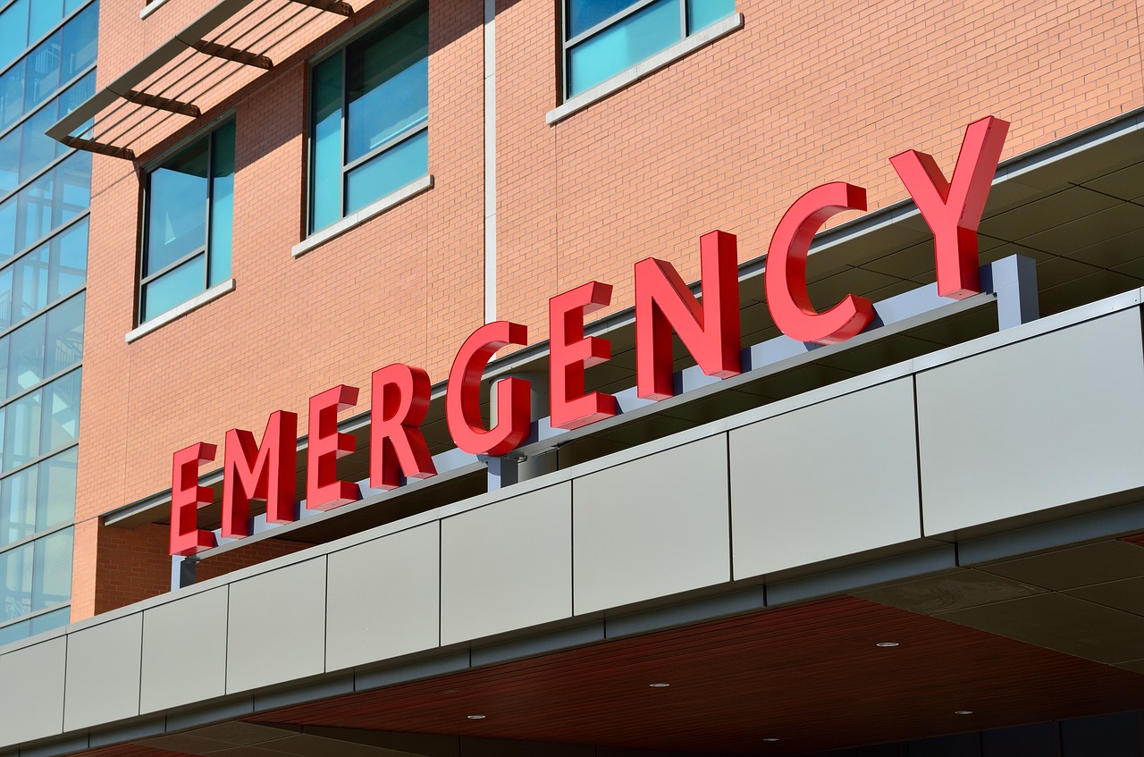 A sign reading "emergency" on the exterior of a building. (stock image via pixabay)