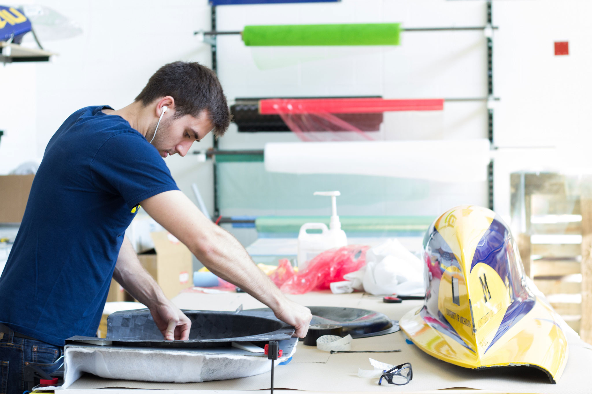 Student, Matthew Morgott, pulls a carbon part out of a mold