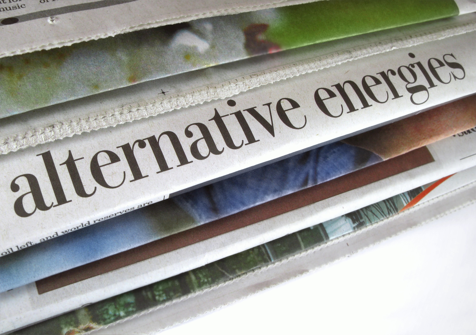Stack of newspapers with headlines about alternative energy. (stock image)