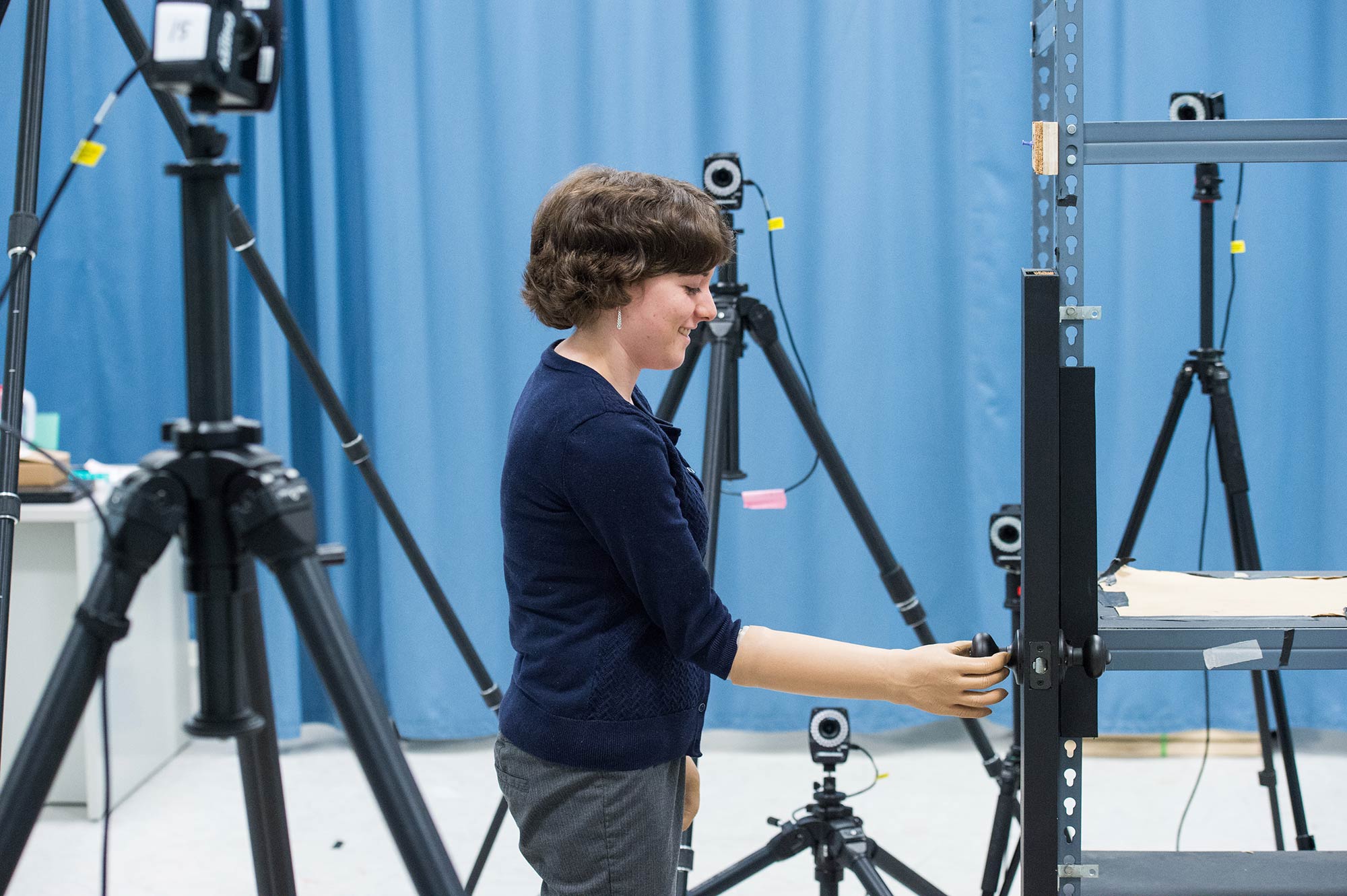 Susannah Engdahl, biomedical engineering doctoral student, opens a prop door in the Biomechanics Laboratory, where experiments are conducted to record muscle movement. Image credit: Austin Thomason, Michigan Photography