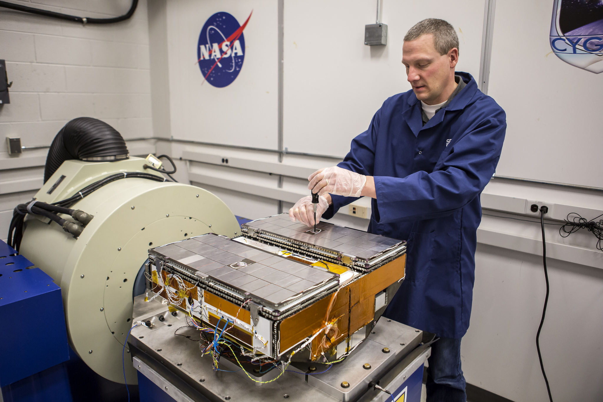 Jonathan Van Noord, research in the Department of Climate and Space Sciences and Engineering, calibrates a prototype of a CYGNSS microsatellite in the Space Research Building. Image credit: Joseph Xu, Michigan Engineering