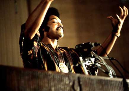 Jackson speaks on a radio broadcast from the headquarters of Operation PUSH, (People United to Save Humanity) at its annual convention. July 1973. Photograph by John H. White.