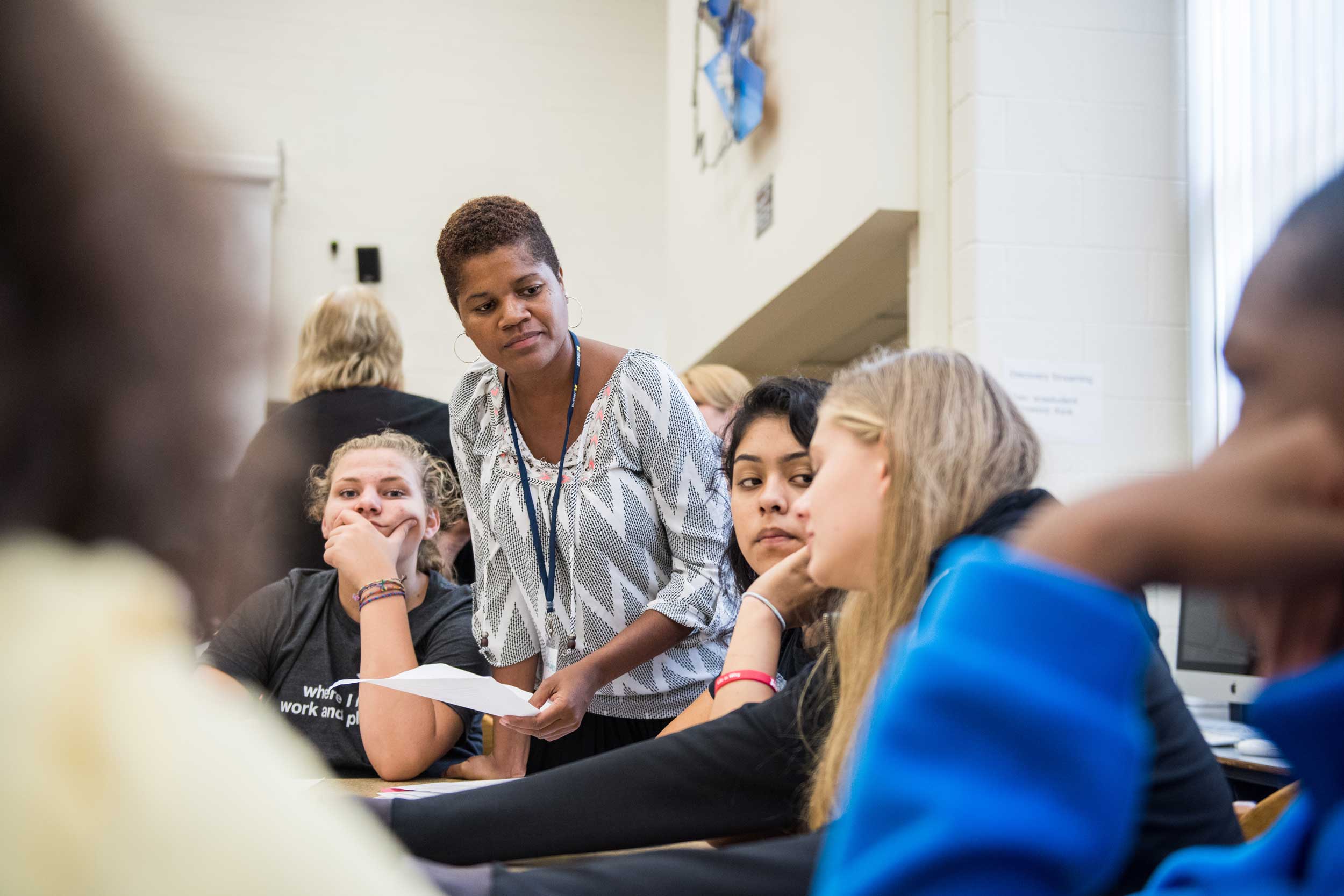 Eighth graders talk with U-M interns about what it means to be a digital citizen. Pictured: Lauren Irvine, U-M Intern Erica Myrick, Leslie Contreras and Lilly Massie. Image credit: Austin Thomason, Michigan Photography