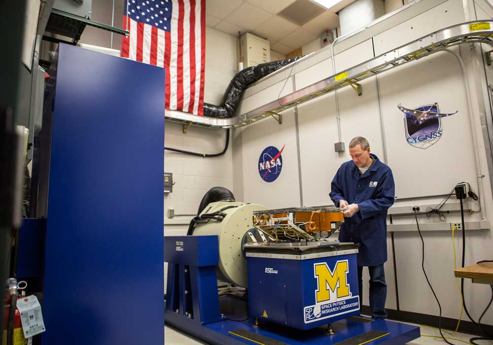 Jonathan Van Noord, research in the Department of Climate and Space Sciences and Engineering, calibrates a prototype of a CYGNSS microsatellite in the Space Research Building. Photo: Joseph Xu, Michigan Engineering.