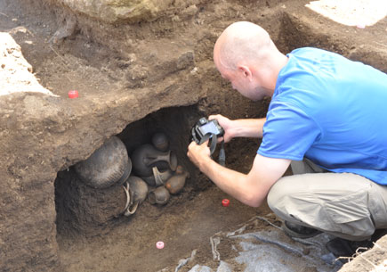 Matt Naglak, a student in the U-M Interdepartmental Program in Classical Art and Archeology, records an exceptionally well-preserved ceramic finds from the niche of an infant tomb dating to the period of city formation, about 7th century B.C.