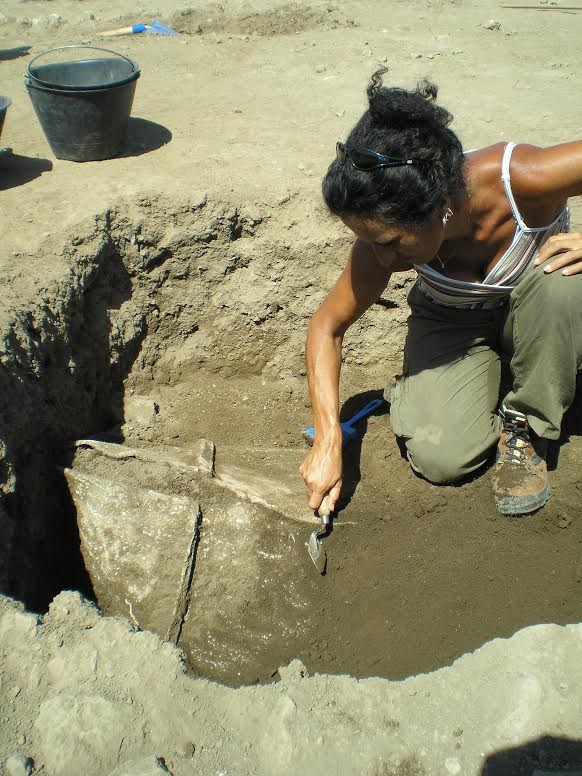Gabii Project field director Anna Gallone and managing director Marcello Mogetta uncover the remains of a lead coffin.