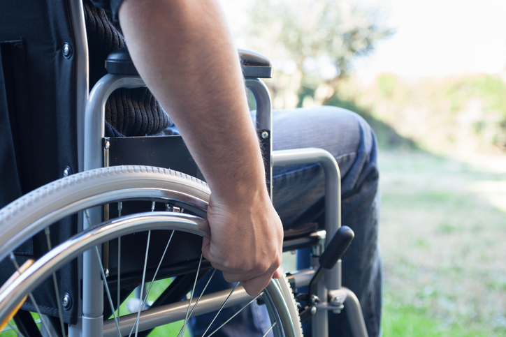A man sits in a wheelchair. (stock image)