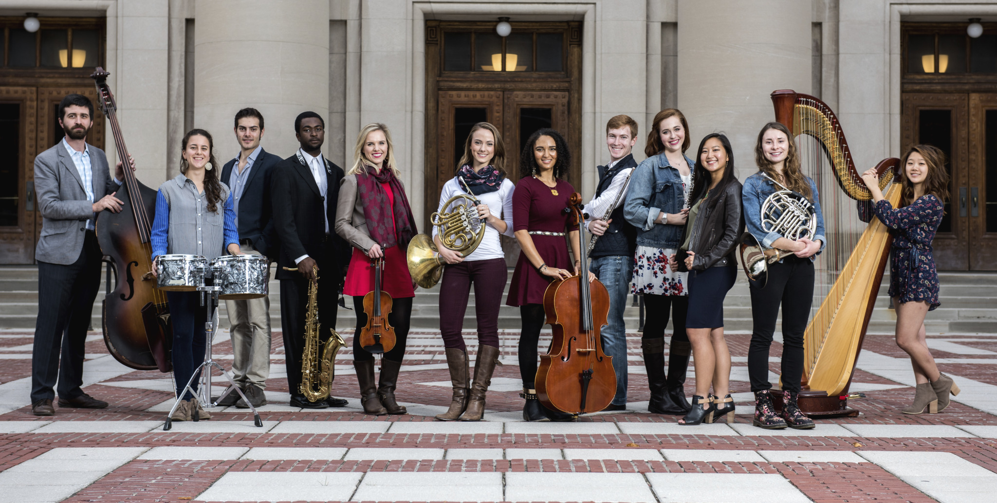University of Michigan School of Music, Theatre & Dance students outside of Ann Arbor's historic Hill Auditorium. The first $100,000 grand prize winner of the M-Prize Chamber Arts Competition will be awarded at Hill Auditorium on May 20, 2016. Left to Right: Andrew Peck, Nicole Patrick, Max Karmazyn, Stephen Grady, Heather Kendrick, Anna Gilpatrick, Anita Graef, Bret Patterson, Anna Thompson, Belinda Rosen, Annie Jeng, Christine Stinchi, Catherine Miller. Photo by Eric Bronson, Michigan Photography.