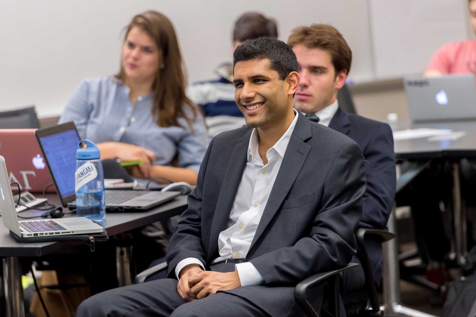 Benjamin Rathi, a senior at the Ross School of Business, reacts in Erik Gordon's class about how to analyze companies as potential investments.