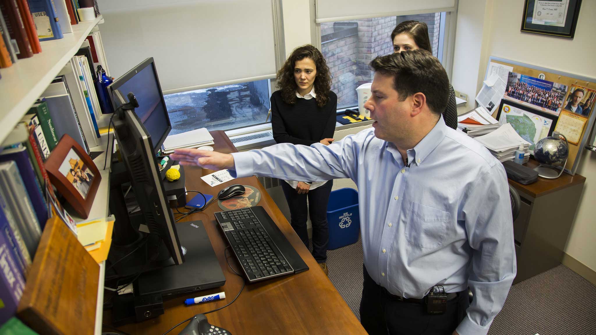 Brian Denton, Professor of Industrial Operations and Engineering, discusses models used prostate screening research with his graduate student researchers, Selin Merdan and Christine Barnett. Image credit: Joseph Xu, Michigan Engineering