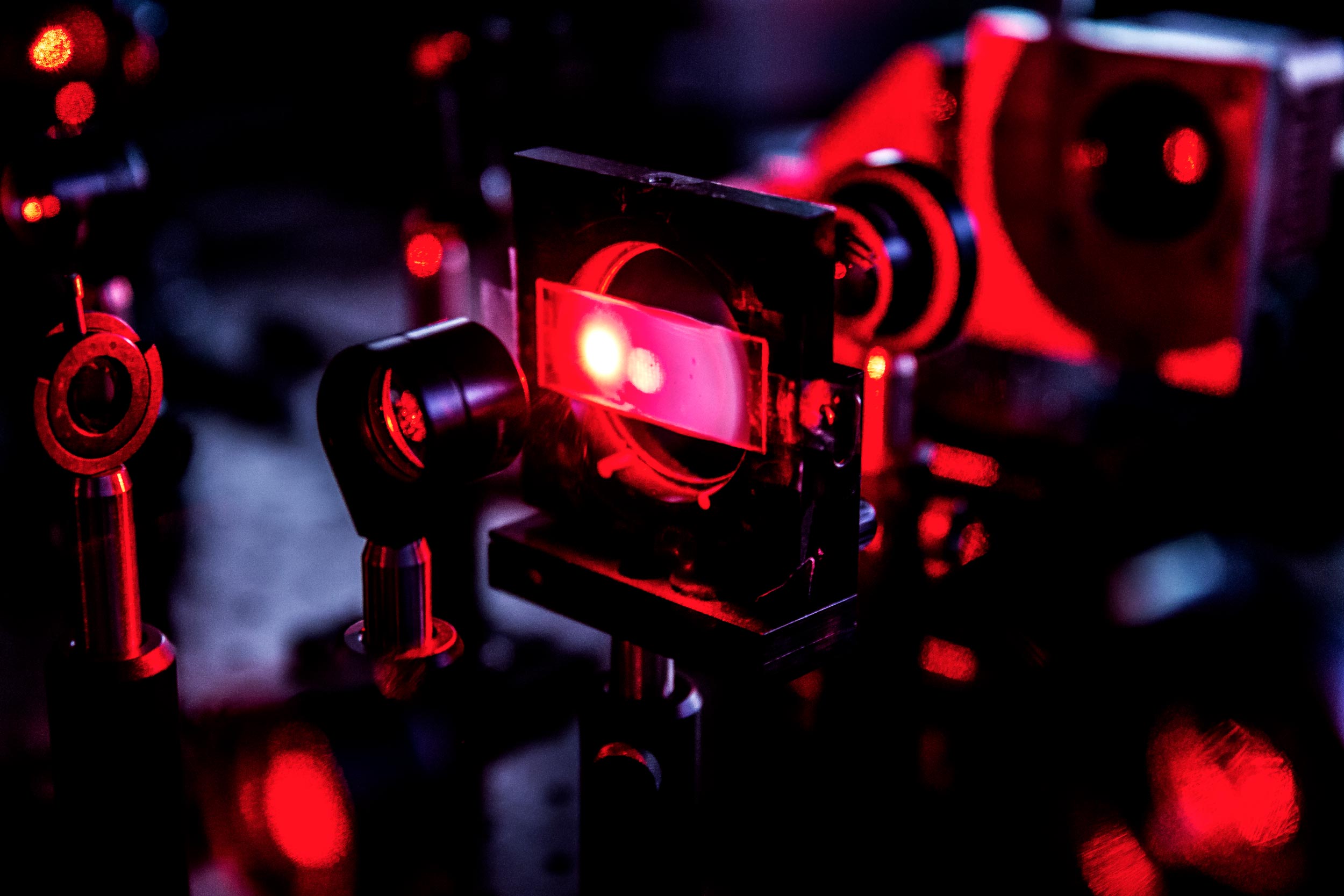A patterned spot of laser light appears on the slide filled with yogurt. Moussa N'Gom and his team measured the brightness of the light getting through for hundreds of patterns, which their algorithm built into a mathematical representation of the yogurt's scattering pattern. Image credit: Joseph Xu, Michigan Engineering