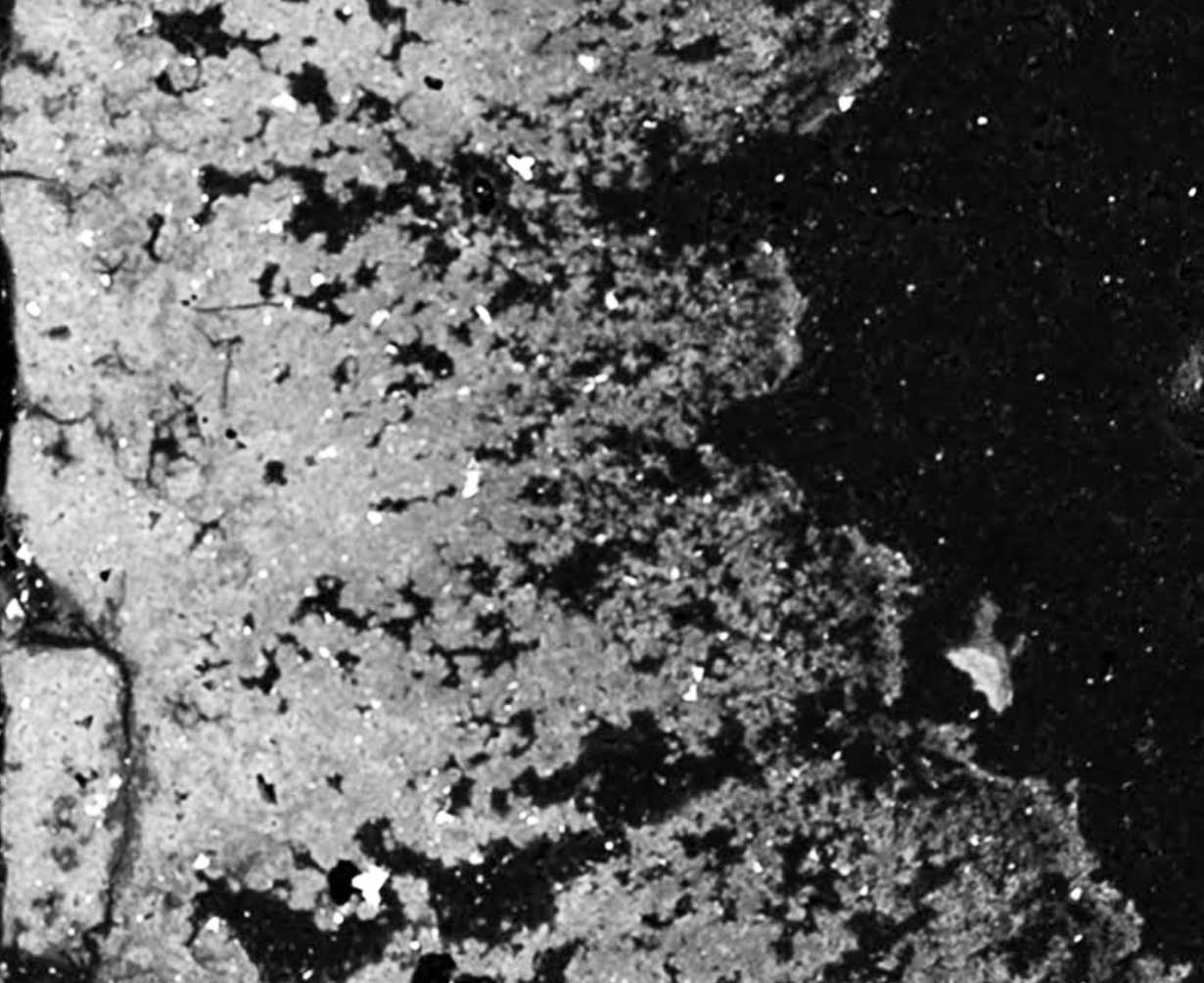 Back scattered electron images of a cross-section of the layer of metal scale, or rust, inside pipe samples from lead service lines in Flint, Michigan. The outside of the pipe is on the left side, and the holes in the “Swiss cheese pattern” are voids where the lead used  to be, say researchers at the University of Michigan College of Engineering. Untreated, corrosive water caused the lead to leach out, leaving behind a mineral skeleton of aluminum and magnesium. Image credit: Brian Ellis