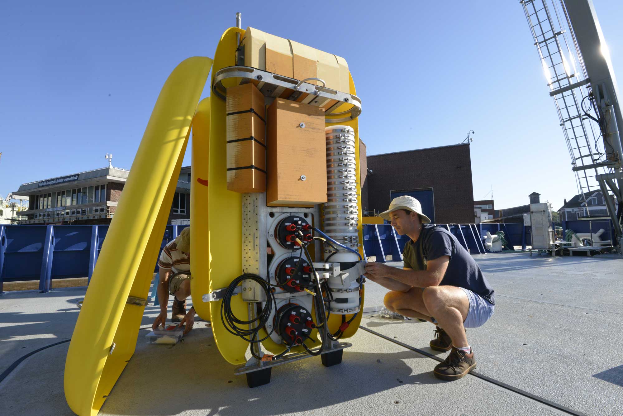 WHOI engineers Mike Jakuba (left) and Daniel Gomez-Ibanez (right) put the finishing touches on the AUV Clio before securing the vehicle's outer skins and heading out for sea trials off the coast of New England. Image credit: Ken Kostel, Woods Hole Oceanographic Institution