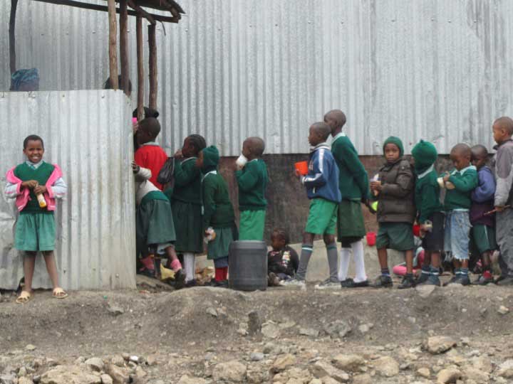 School childrens stand in line. Image credit: William Davidson Institute