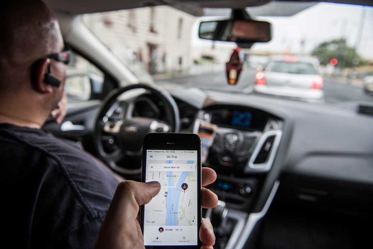 A passenger uses a rideshare app. Image credit: @kmgolden via Twitter