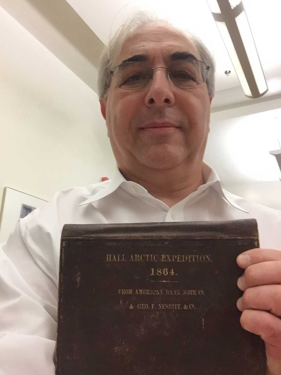 Russell Taichman holds a book detailing the 1864 Hall Arctic Expedition. Images courtesy: Russell Taichman