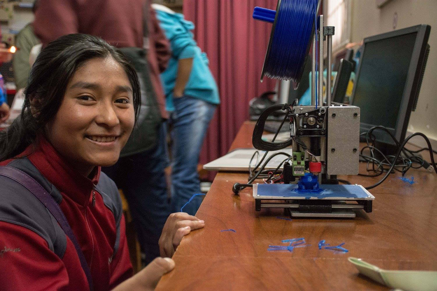 A senior student from San Francisco de Asis high school in Puno, Peru, uses a 3D  to print a prototype she designed using Fusion 360 software.