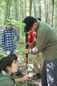 A participant in a June 2016 workshop at the U-M Biological Station learns techniques to measure soil carbon. Organic matter in soil, such as decomposing plant and animal residues, stores more carbon than do plants and the atmosphere combined. Image credit: Kailey Marcinkowski, Northern Institute of Applied Climate Science
