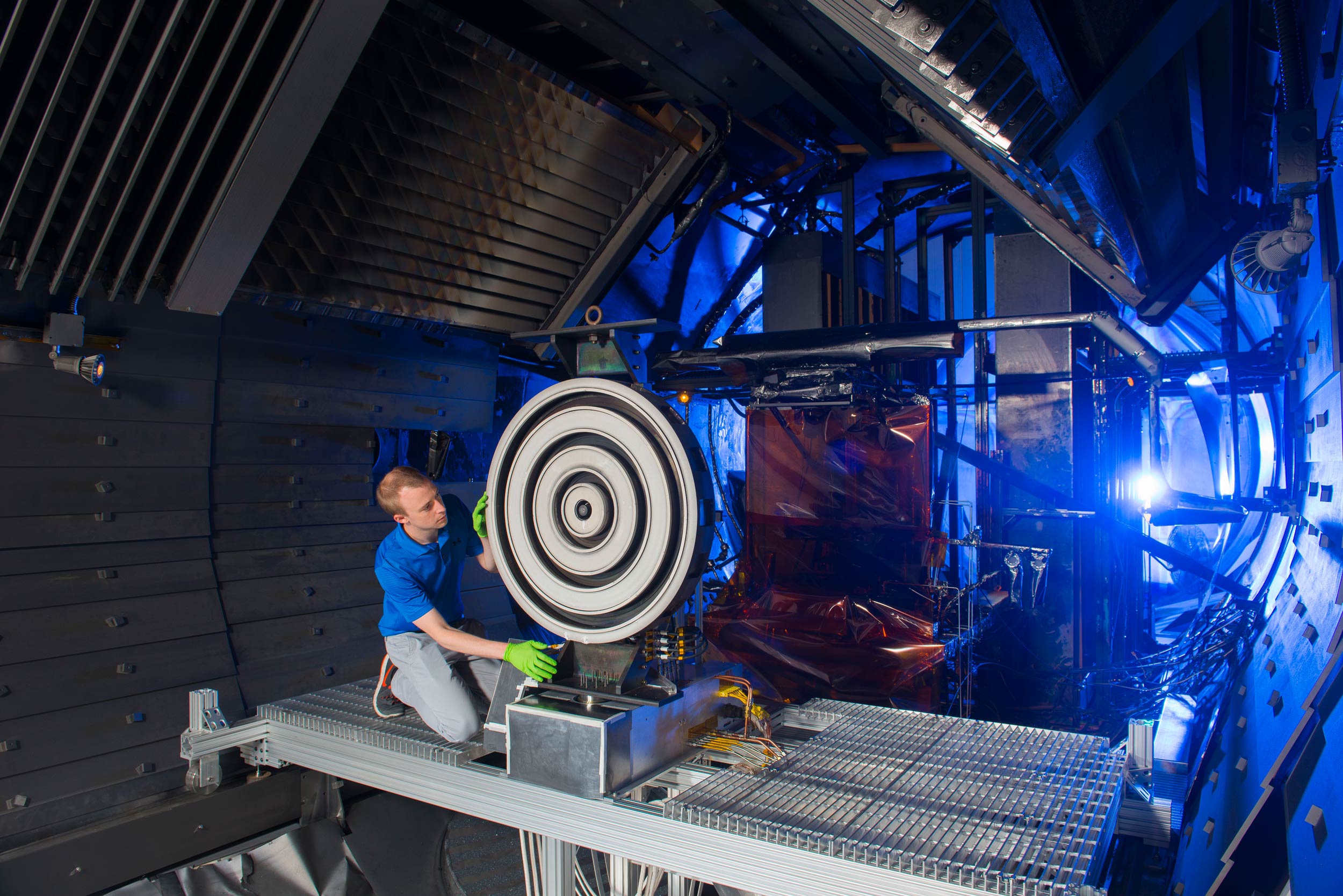 Scott Hall makes some final adjustments on the thruster before the test begins. Image credit: NASA