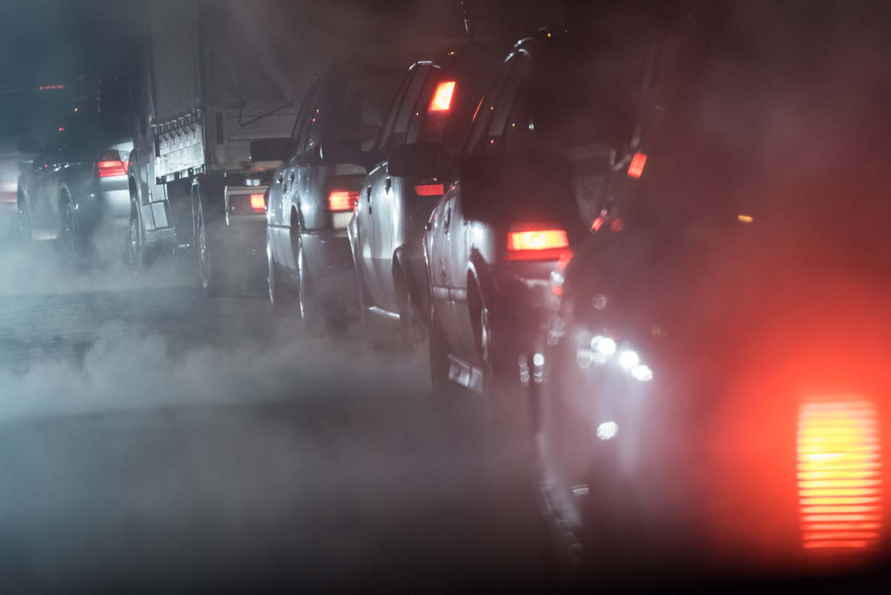A line of cars and trucks and emissions. (stock image)