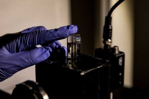 Minjeong Cha, MSE PhD Student, applies a gel made up of chiromagnetic nanoparticles that are a conduit for modulating light to a laser apparatus. Image credit: Joseph Xu, Michigan Engineering