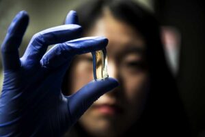 Cha holds a gel made up of chiromagnetic nanoparticles that are a conduit for modulating light. Image credit: Joseph Xu, Michigan Engineering