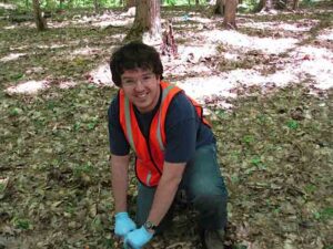 Former University of Michigan postdoctoral research fellow Zac Freedman collects a soil sample at a study site in Oceana County, Michigan. This location is one of four Michigan study sites used in a U-M-led study examining how nitrogen deposition and a changing climate affect the growth of sugar maples. Photo by Rima Upchurch.