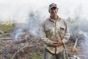 University of Michigan ecologist and biogeochemist Luke Nave during a prescribed fire at the U-M Biological Station in October 2017. Periodic burns at the station allow researchers to address critical questions about climate change and the long-term storage of carbon in forests and their soils. Image credit: Roger Hart, Michigan Photography.