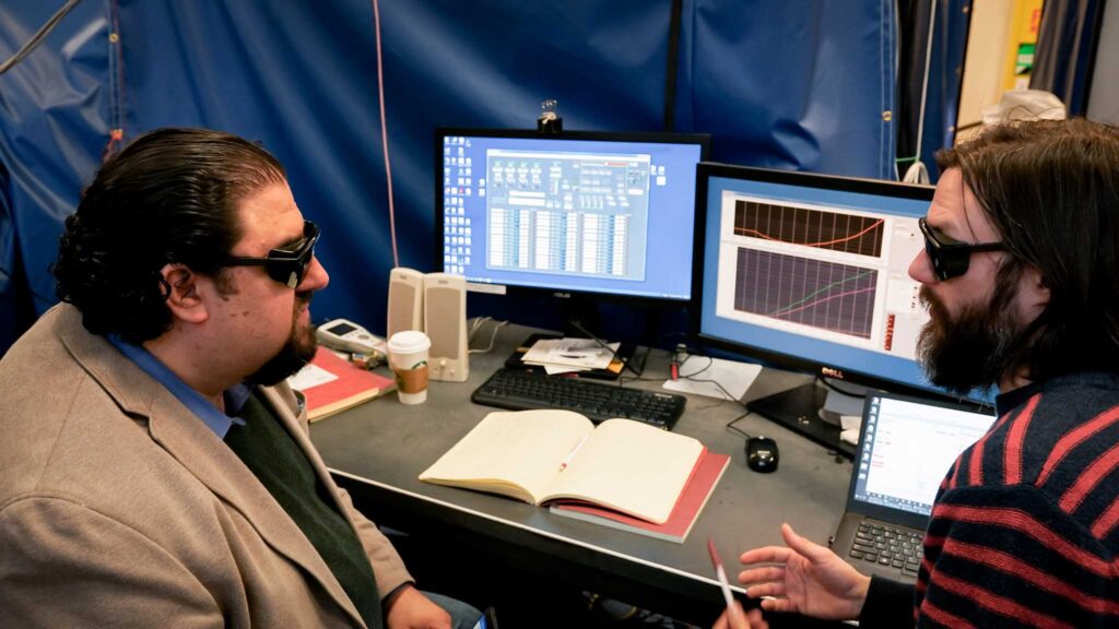 Justin Kasper, (left), a University of Michigan associate professor of climate and space sciences engineering, awaits test results with Anthony Case, an astrophysicist at the Harvard Smithsonian Institute for Astrophysics. Image creidt: Levi Hutmacher, Michigan Engineering