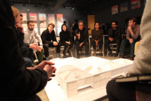 Architect Mark Lee leads a discussion about the various design concepts students have created for the roof of a campus building. 