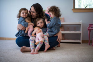 Mom holding her three triplets