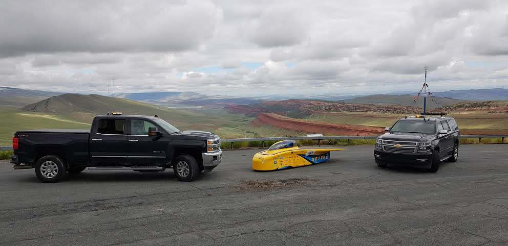 Several vehicles in the University of Michigan Solar Car Team's caravan. When it's on the road, Novum travels in a caravan behind the lead vehicle and in front of the chase vehicle. Photo by Rishabh Goel